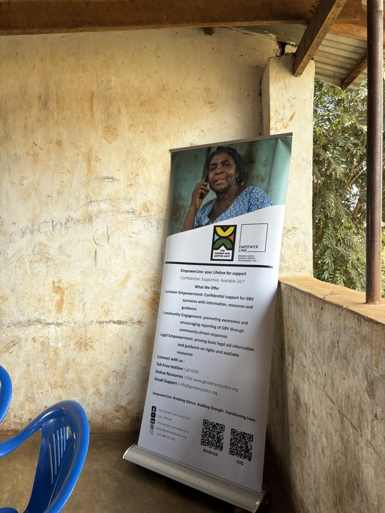 A pullup banner displaying information for the Gender and Justice Unit's support tool EmpowerLine.