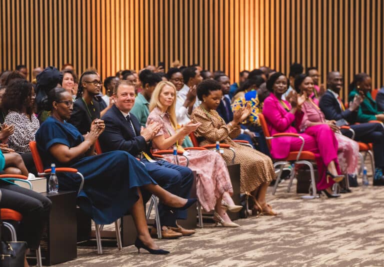 Martin Segal smiles at the camera from the front row of the 2023 Annual Meeting