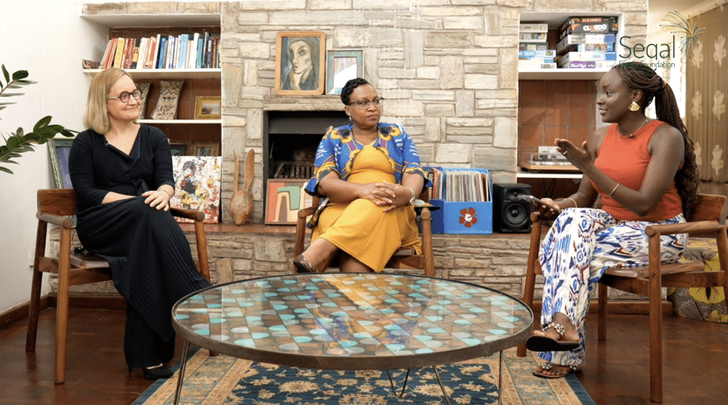 Video still of three women sitting around a table