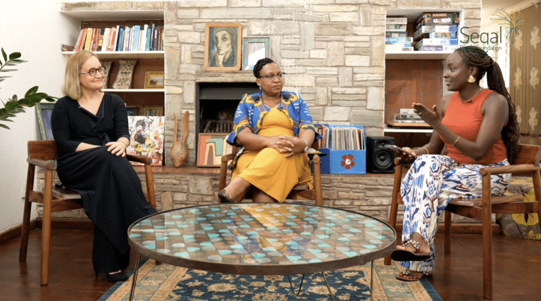 Video still of three women sitting around a table