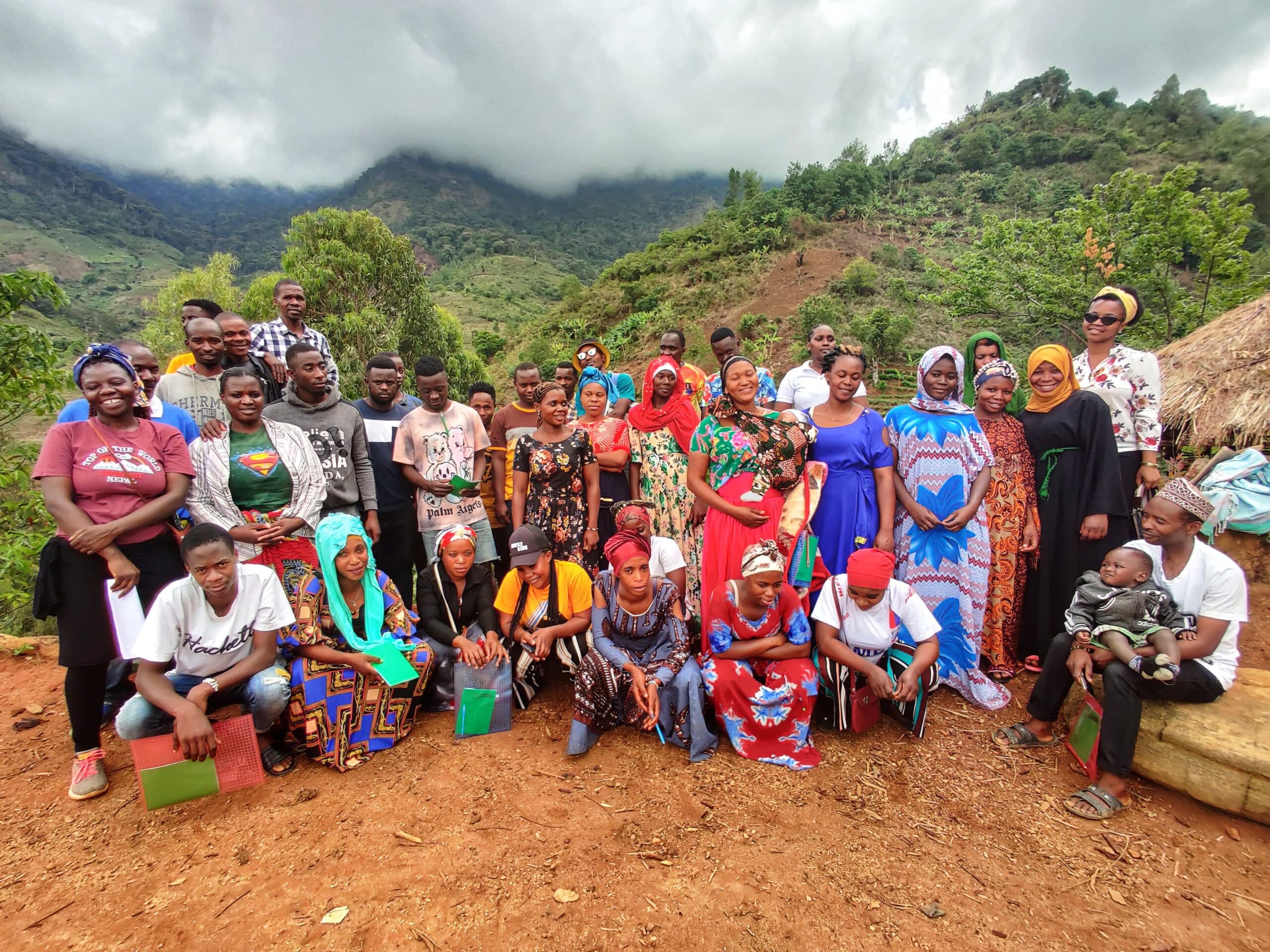 A group of 36 people smiling in a rural Tanzanian setting