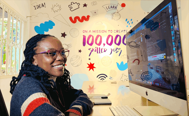 A Ugandan woman sits at a computer monitor