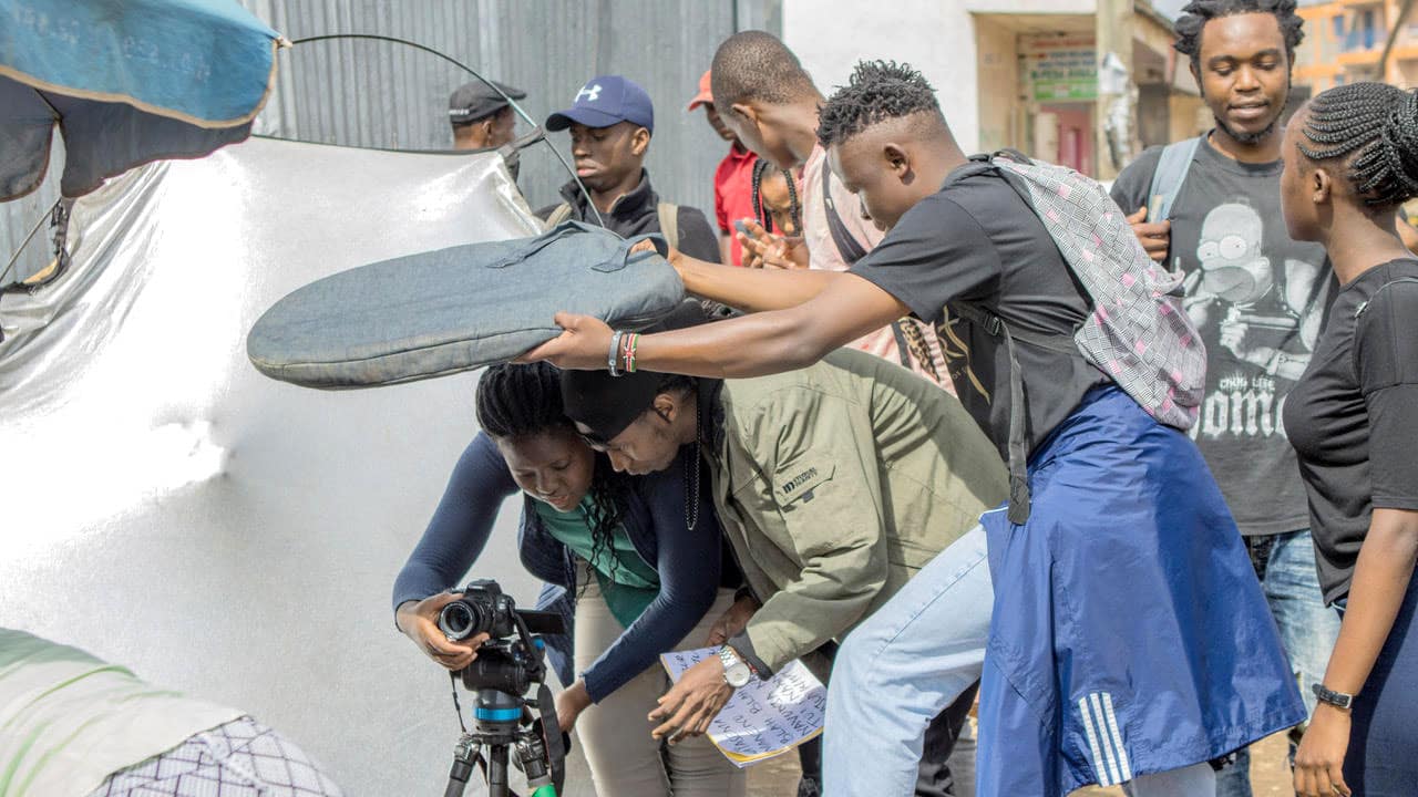 Young Kenyans work behind the scenes to film a video