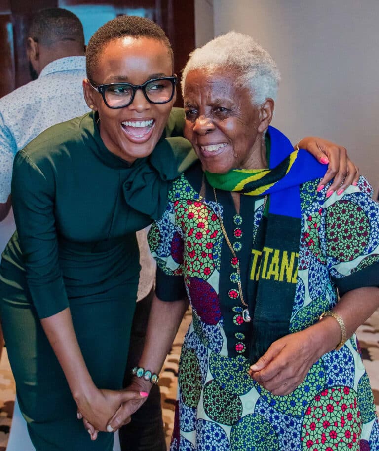 A young Tanzanian woman hugs an elderly Tanzanian woman