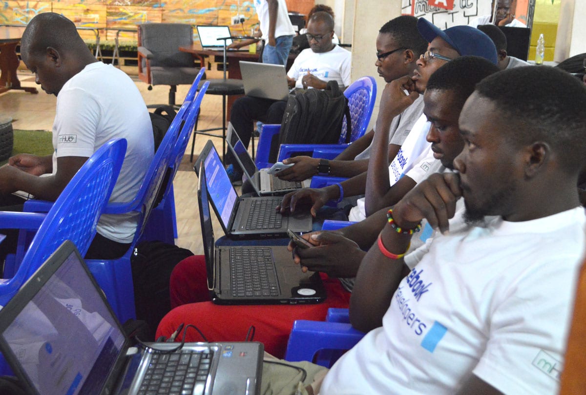 A room of young Malawian men on their laptops