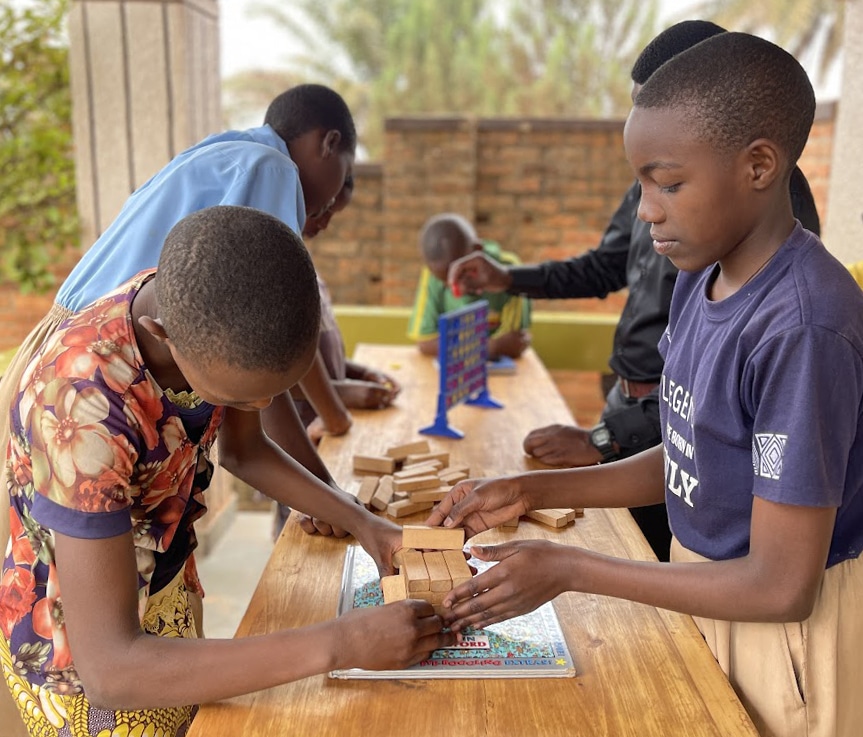 Two Rwandan children play a game together